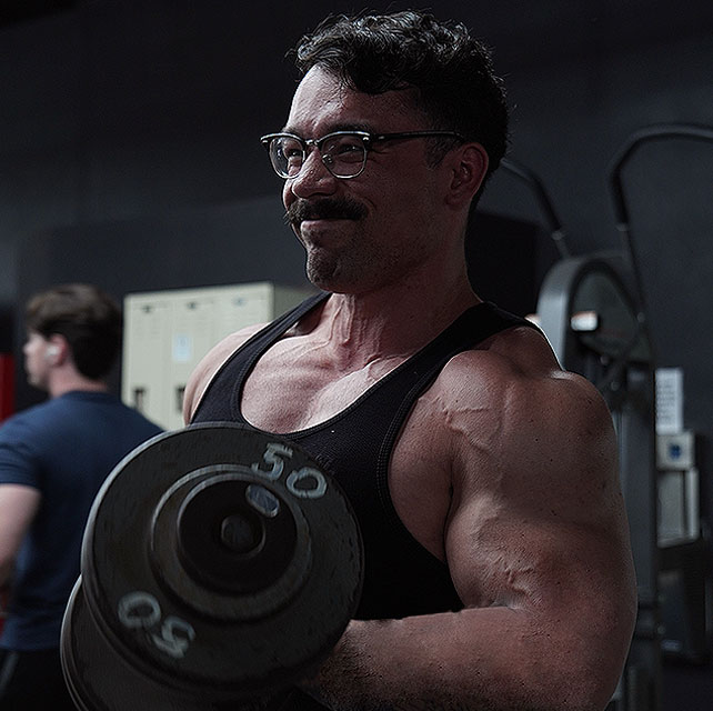A member training arms at MetroFlex Gym Oceanside.